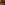 Row of nail polish bottles on a wooden table with a warm, blurred indoor background
